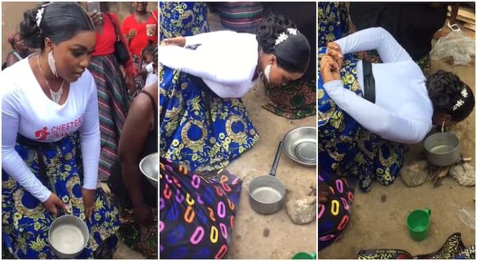 Beautiful bride uses mouth to put pot on fire as wedding rite