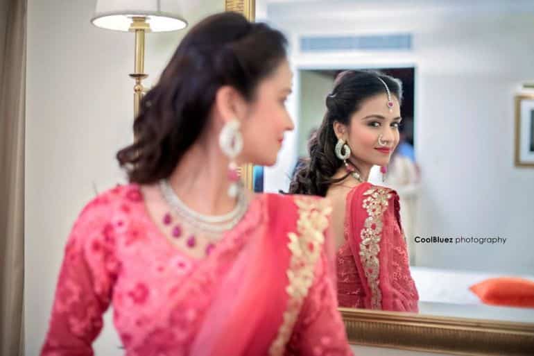 A mirror pose with a woman wearing lehenga