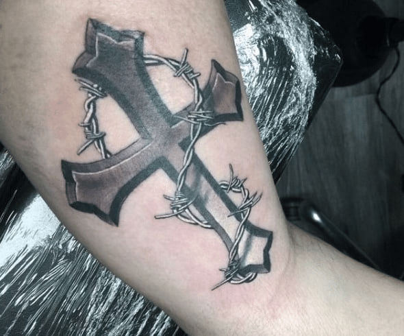 Barbed wire wrapped around a cross tattoo