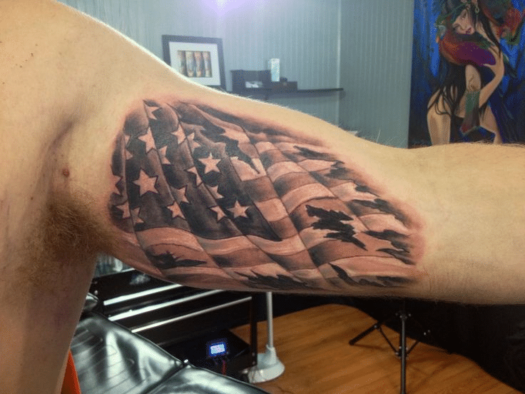 Barbed wire tattoo with a flag