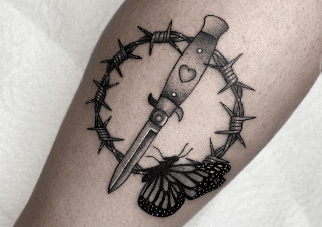 Barbed wire tattoo with a sword