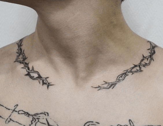 Barbed wire tattoo around the collarbone