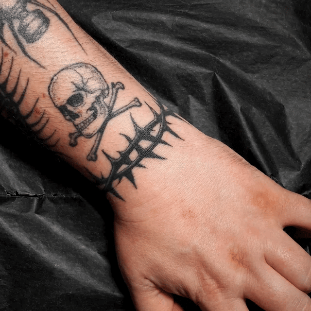 Barbed wire tattoo with skull and crossbones