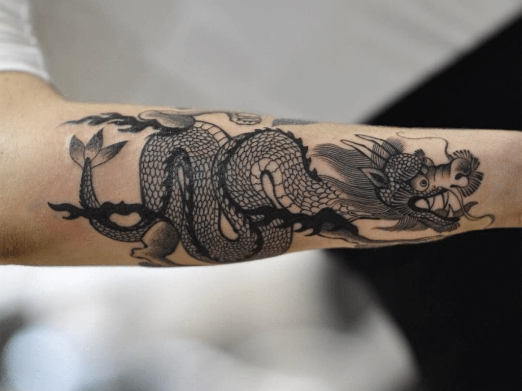 Barbed wire tattoo with a dragon