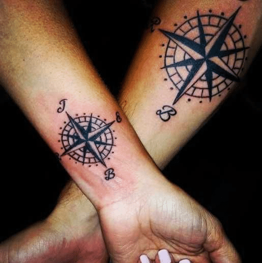 Barbed wire tattoo with a compass
