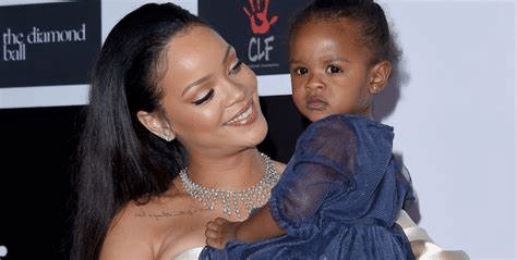Rihanna posing with a baby