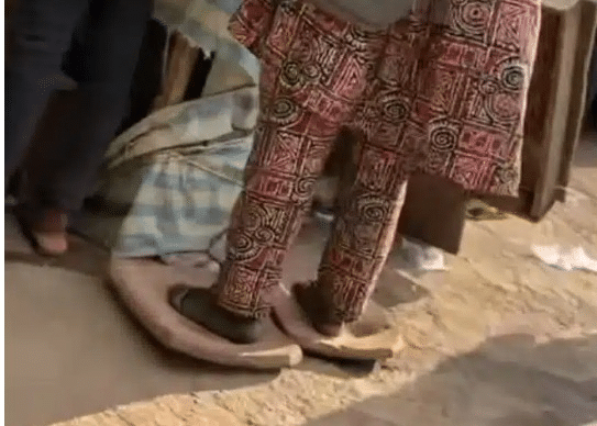 man storms market with oversized slippers