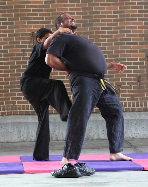 Troy and his father demonstrating the self defense Bond teaches for children