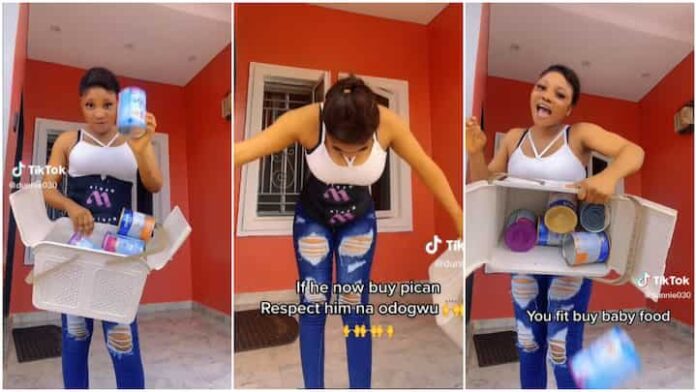 Nigerian lady shows off empty tins of baby food, praises her husband for being a father