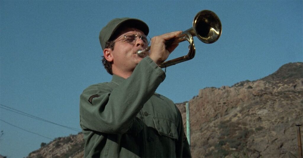 Gary playing the trumpet on the set of MASH