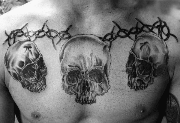 Barbed wire tattoo with skulls