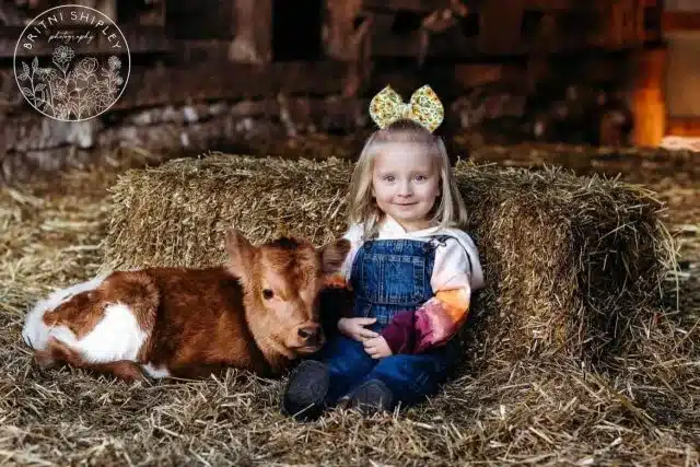A little girl with her mini cow