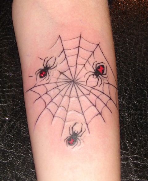 triple small spider tattoo in a web